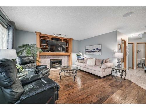 100 Cove Road, Chestermere, AB - Indoor Photo Showing Living Room With Fireplace