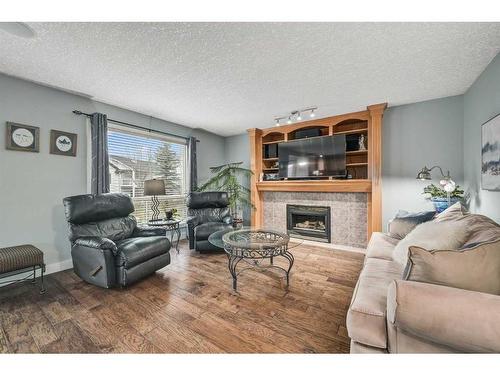 100 Cove Road, Chestermere, AB - Indoor Photo Showing Living Room With Fireplace