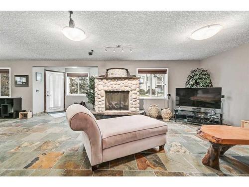 100 Cove Road, Chestermere, AB - Indoor Photo Showing Living Room With Fireplace