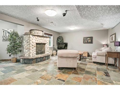 100 Cove Road, Chestermere, AB - Indoor Photo Showing Living Room With Fireplace