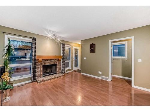 219 Coachway Road Sw, Calgary, AB - Indoor Photo Showing Living Room With Fireplace