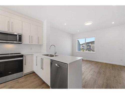 1303-280 Chelsea Road, Chestermere, AB - Indoor Photo Showing Kitchen With Stainless Steel Kitchen With Double Sink