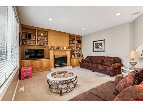 125 Evergreen Place Sw, Calgary, AB - Indoor Photo Showing Living Room With Fireplace