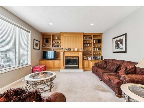 125 Evergreen Place Sw, Calgary, AB - Indoor Photo Showing Living Room With Fireplace