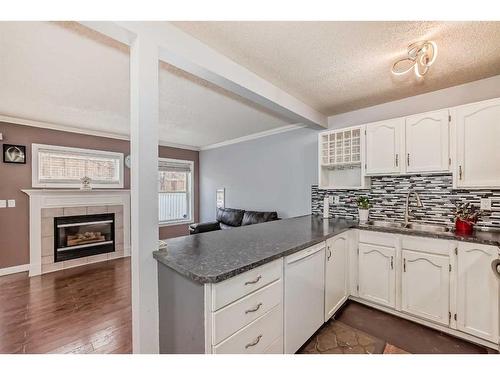 123 Country Hills Villas Nw, Calgary, AB - Indoor Photo Showing Kitchen With Fireplace