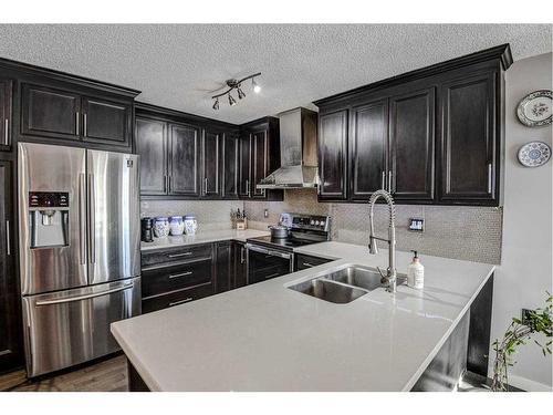 56 Strathclair Place Sw, Calgary, AB - Indoor Photo Showing Kitchen With Stainless Steel Kitchen With Double Sink With Upgraded Kitchen