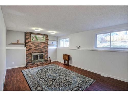 56 Strathclair Place Sw, Calgary, AB - Indoor Photo Showing Living Room With Fireplace