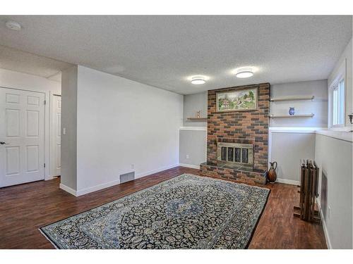 56 Strathclair Place Sw, Calgary, AB - Indoor Photo Showing Other Room With Fireplace