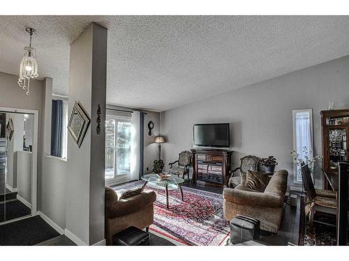 56 Strathclair Place Sw, Calgary, AB - Indoor Photo Showing Living Room With Fireplace