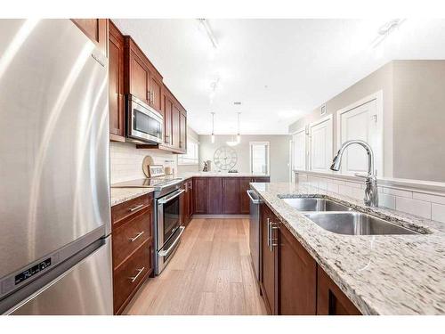 212-1905 27 Avenue Sw, Calgary, AB - Indoor Photo Showing Kitchen With Stainless Steel Kitchen With Double Sink With Upgraded Kitchen