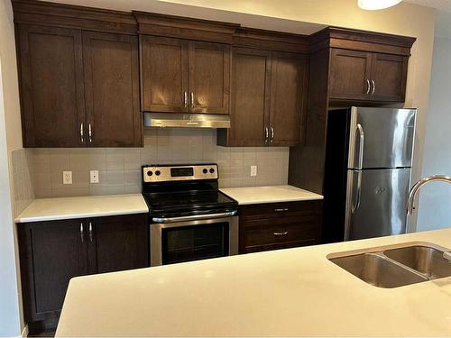 106 Panatella Walk Nw, Calgary, AB - Indoor Photo Showing Kitchen With Stainless Steel Kitchen With Double Sink