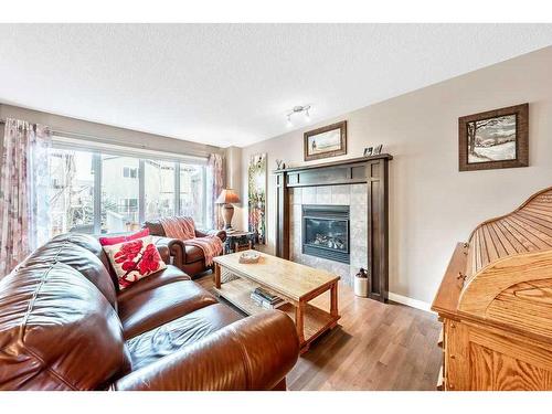 24 Thoroughbred Boulevard, Cochrane, AB - Indoor Photo Showing Living Room With Fireplace