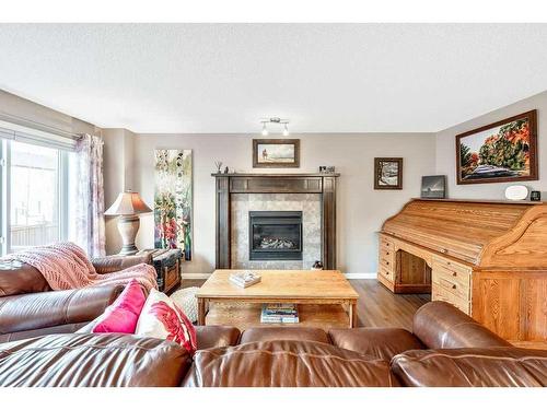 24 Thoroughbred Boulevard, Cochrane, AB - Indoor Photo Showing Living Room With Fireplace