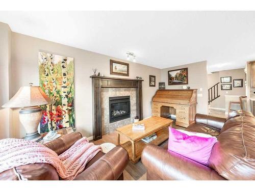 24 Thoroughbred Boulevard, Cochrane, AB - Indoor Photo Showing Living Room With Fireplace