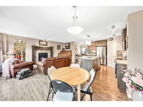 24 Thoroughbred Boulevard, Cochrane, AB - Indoor Photo Showing Dining Room With Fireplace