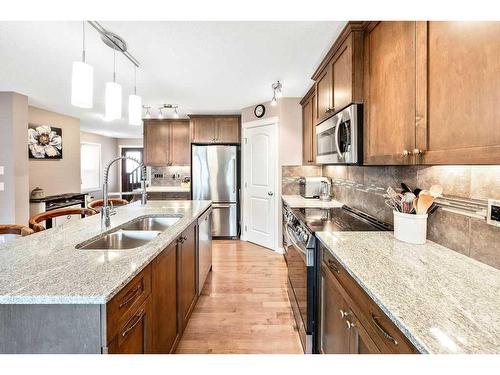 24 Thoroughbred Boulevard, Cochrane, AB - Indoor Photo Showing Kitchen With Double Sink With Upgraded Kitchen