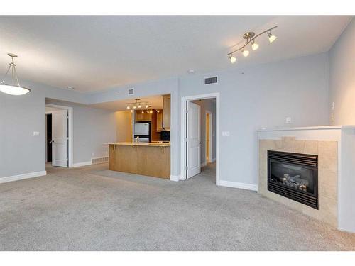 1403-910 5 Avenue Sw, Calgary, AB - Indoor Photo Showing Living Room With Fireplace