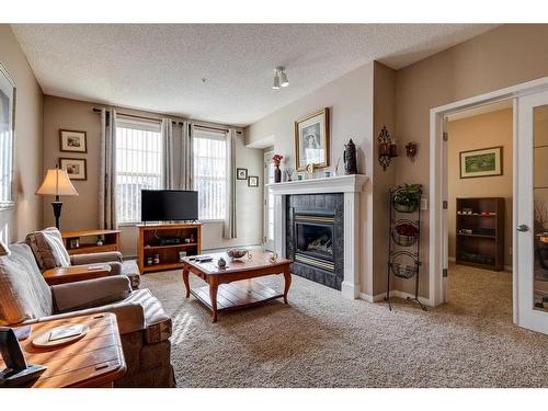 5212-14645 6 Street Sw, Calgary, AB - Indoor Photo Showing Living Room With Fireplace