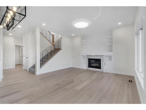 14 Ranchers Meadows, Okotoks, AB - Indoor Photo Showing Other Room With Fireplace