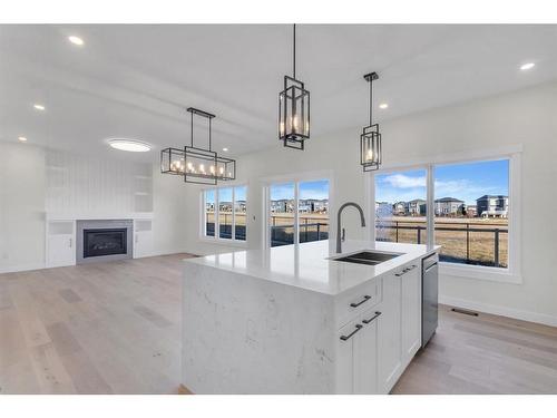 14 Ranchers Meadows, Okotoks, AB - Indoor Photo Showing Kitchen With Fireplace With Upgraded Kitchen