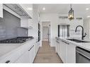 14 Ranchers Meadows, Okotoks, AB  - Indoor Photo Showing Kitchen With Double Sink With Upgraded Kitchen 