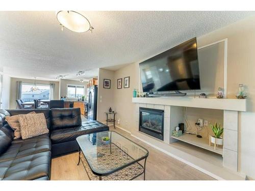 131 Covepark Way Ne, Calgary, AB - Indoor Photo Showing Living Room With Fireplace