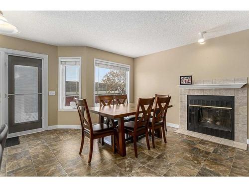 436 Mt Lorette Place Se, Calgary, AB - Indoor Photo Showing Dining Room With Fireplace