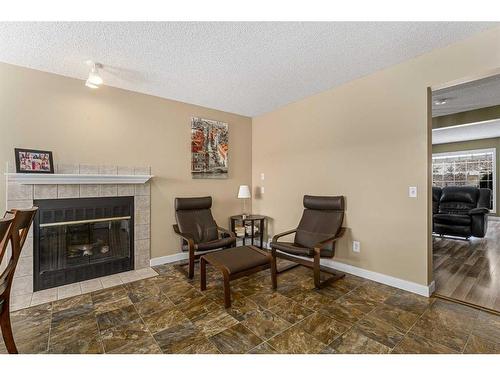 436 Mt Lorette Place Se, Calgary, AB - Indoor Photo Showing Living Room With Fireplace