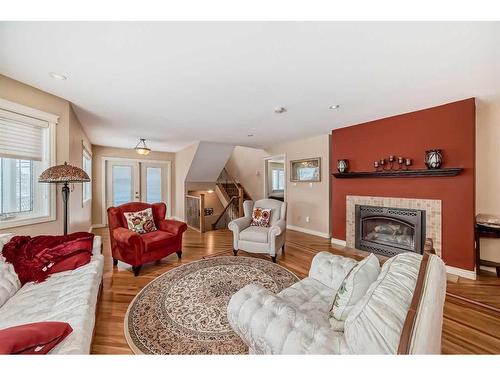 935 Hunterston Hill Nw, Calgary, AB - Indoor Photo Showing Living Room With Fireplace