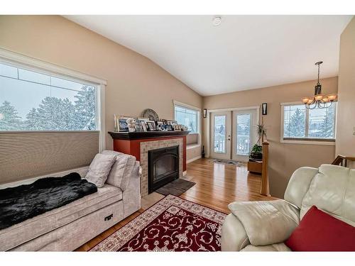 935 Hunterston Hill Nw, Calgary, AB - Indoor Photo Showing Living Room With Fireplace