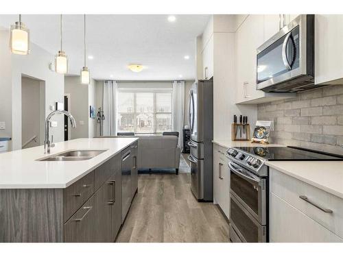 30 D'Arcy Boulevard, Okotoks, AB - Indoor Photo Showing Kitchen With Stainless Steel Kitchen With Double Sink With Upgraded Kitchen