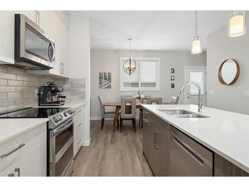 30 D'Arcy Boulevard, Okotoks, AB - Indoor Photo Showing Kitchen With Stainless Steel Kitchen With Double Sink With Upgraded Kitchen