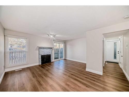 148-54 Glamis Green Sw, Calgary, AB - Indoor Photo Showing Living Room With Fireplace