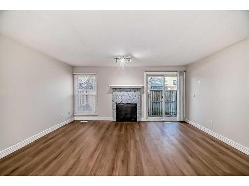 148-54 Glamis Green Sw, Calgary, AB - Indoor Photo Showing Living Room With Fireplace