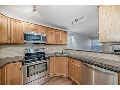 148-54 Glamis Green Sw, Calgary, AB - Indoor Photo Showing Kitchen With Stainless Steel Kitchen