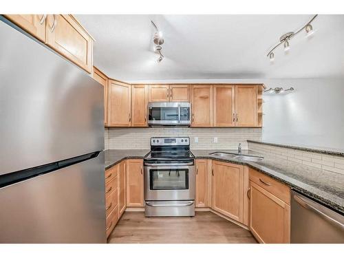 148-54 Glamis Green Sw, Calgary, AB - Indoor Photo Showing Kitchen With Stainless Steel Kitchen With Double Sink