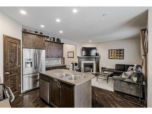 170 Brightonwoods Grove Se, Calgary, AB - Indoor Photo Showing Kitchen With Fireplace With Stainless Steel Kitchen With Double Sink