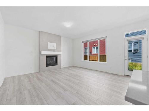 40 Carringham Gate Nw, Calgary, AB - Indoor Photo Showing Living Room With Fireplace