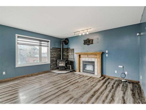 6113 Saddlehorn Drive Ne, Calgary, AB - Indoor Photo Showing Living Room With Fireplace