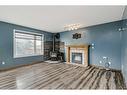 6113 Saddlehorn Drive Ne, Calgary, AB  - Indoor Photo Showing Living Room With Fireplace 