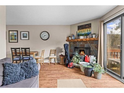 B-133 Park Avenue, Banff, AB - Indoor Photo Showing Living Room With Fireplace