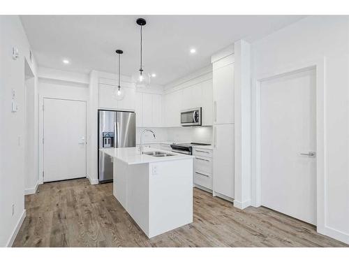 4307-111 Wolf Creek Drive Se, Calgary, AB - Indoor Photo Showing Kitchen With Double Sink