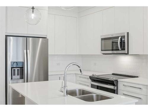 4307-111 Wolf Creek Drive Se, Calgary, AB - Indoor Photo Showing Kitchen With Double Sink With Upgraded Kitchen