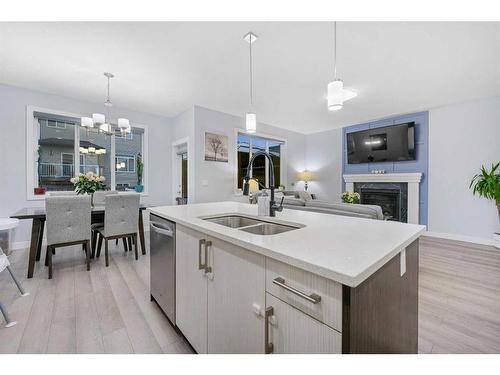 391 Bayview Way Sw, Airdrie, AB - Indoor Photo Showing Kitchen With Fireplace With Double Sink