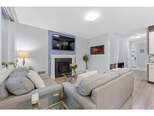 391 Bayview Way Sw, Airdrie, AB - Indoor Photo Showing Living Room With Fireplace