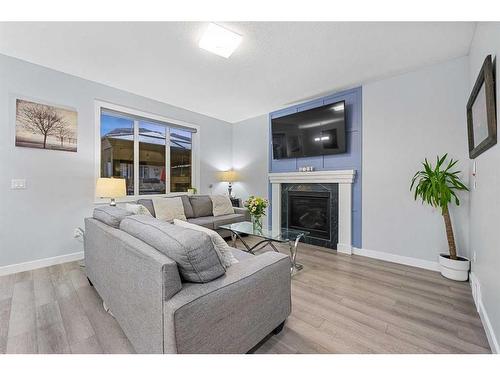 391 Bayview Way Sw, Airdrie, AB - Indoor Photo Showing Living Room With Fireplace