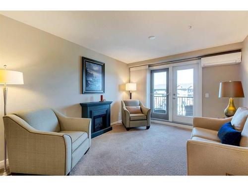 2307-402 Kincora Glen Road Nw, Calgary, AB - Indoor Photo Showing Living Room With Fireplace