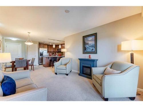 2307-402 Kincora Glen Road Nw, Calgary, AB - Indoor Photo Showing Living Room With Fireplace