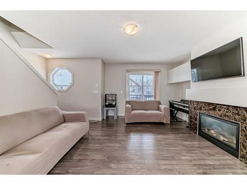 257 Copperpond Landing Se, Calgary, AB - Indoor Photo Showing Living Room With Fireplace