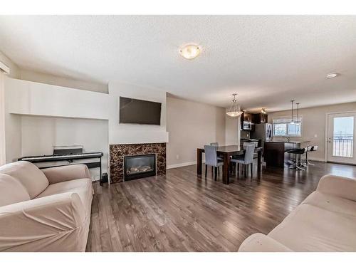 257 Copperpond Landing Se, Calgary, AB - Indoor Photo Showing Living Room With Fireplace